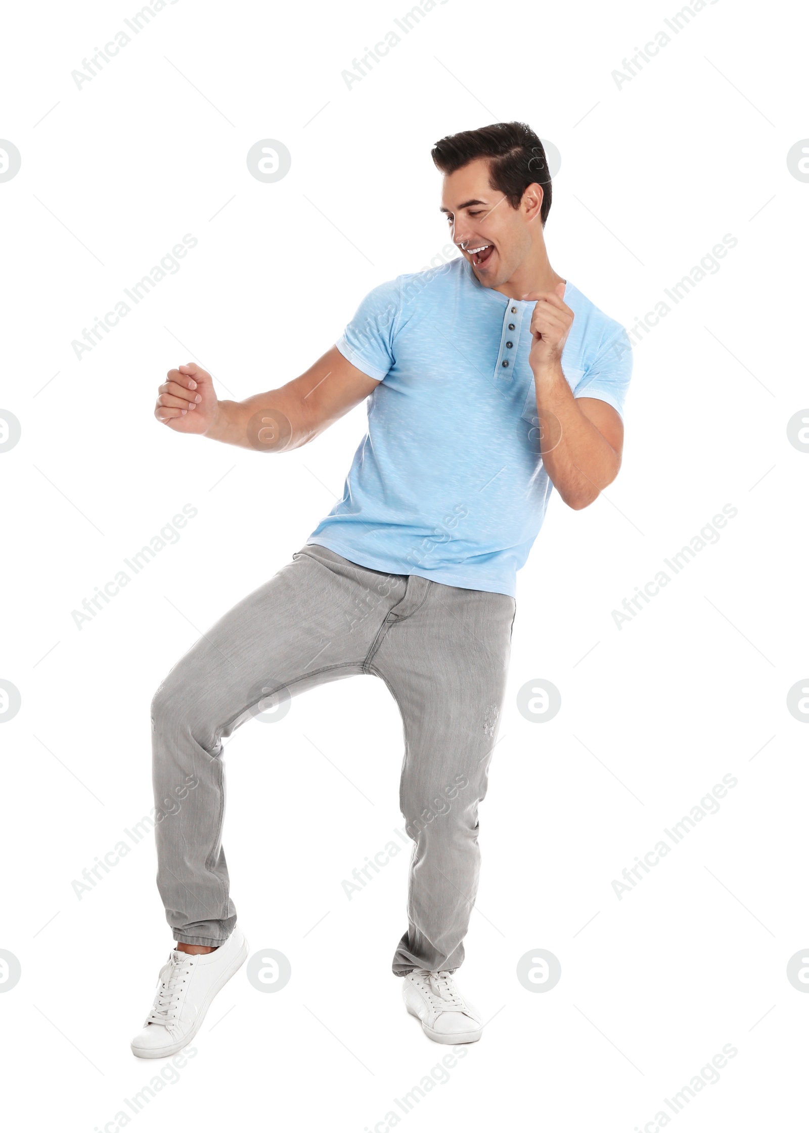 Photo of Handsome young man dancing on white background