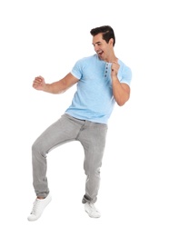 Photo of Handsome young man dancing on white background