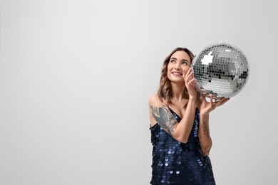 Photo of Beautiful woman with disco ball on white background, space for text
