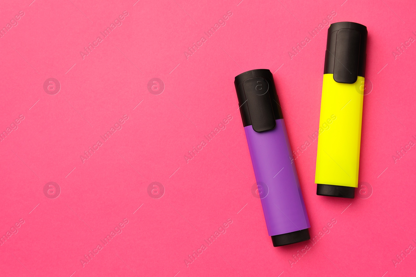 Photo of Bright color markers on pink background, flat lay. Space for text