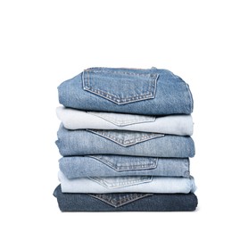 Stack of different folded jeans isolated on white