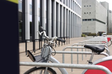 Bicycle near metal stands on city street