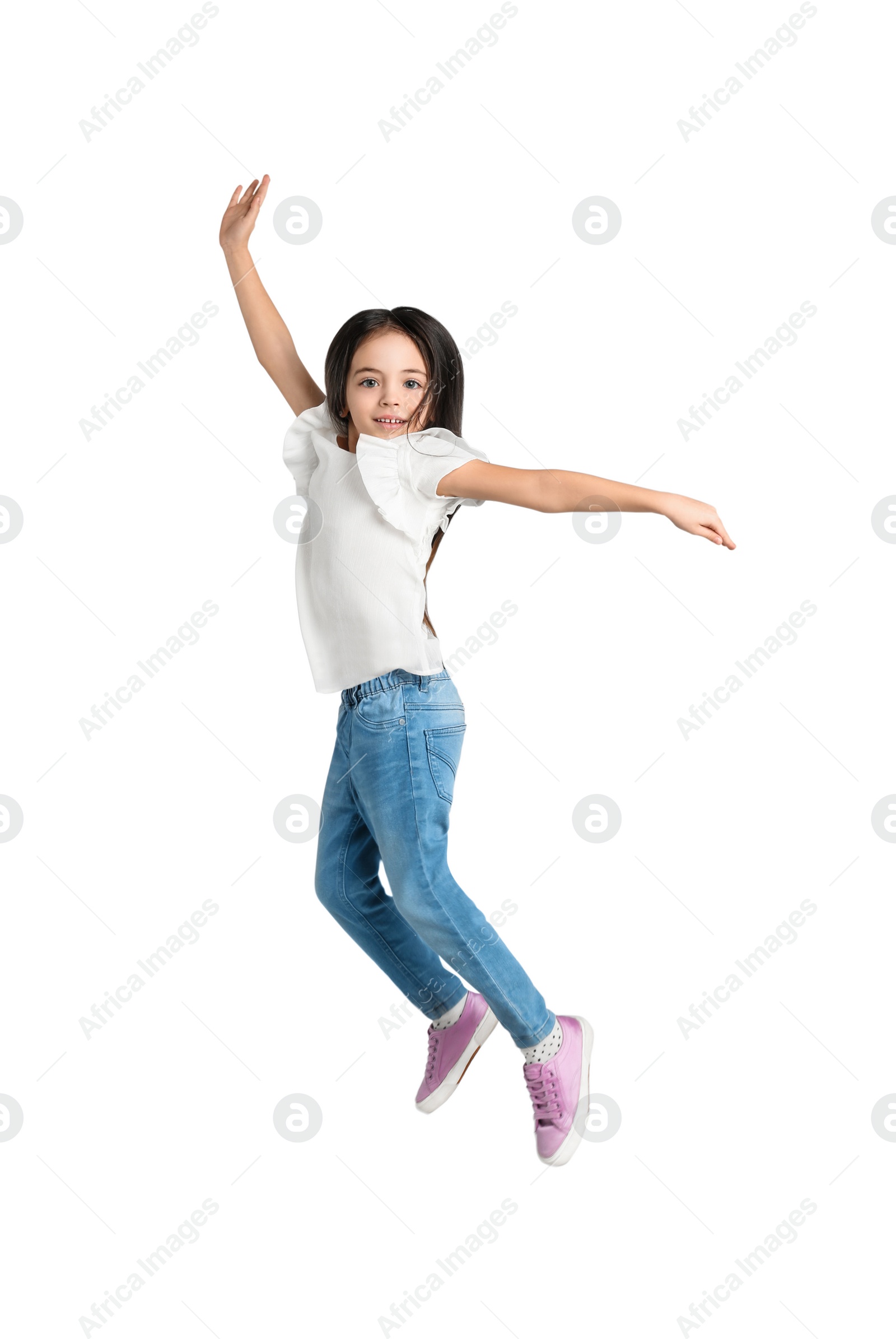 Photo of Cute little girl jumping on light grey background