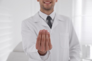 Photo of Dentist holding something in clinic, closeup view
