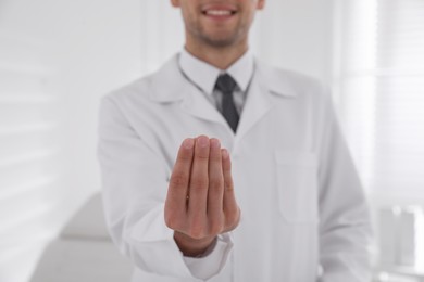 Dentist holding something in clinic, closeup view