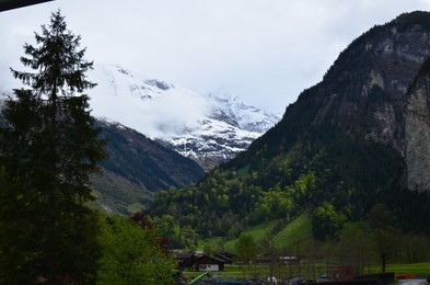 Picturesque view of mountain landscape with forest and village