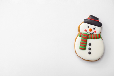 Photo of Christmas snowman shaped gingerbread cookie on white background, top view