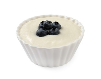 Photo of Delicious semolina pudding with blueberries in bowl on white background