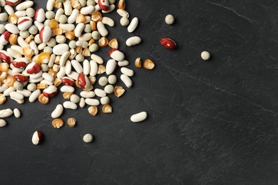 Mixed vegetable seeds on grey background, flat lay. Space for text