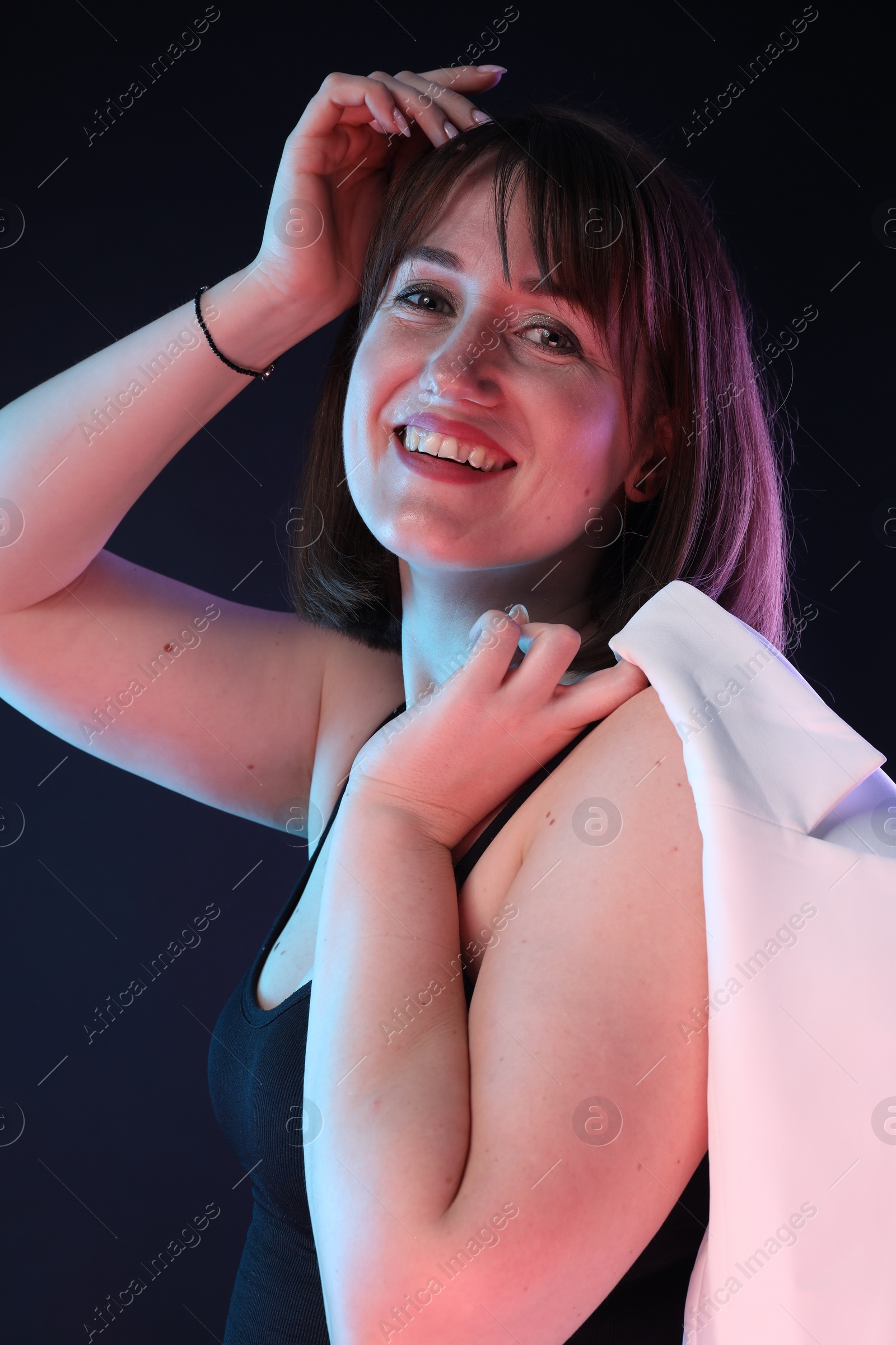 Photo of Portrait of happy woman on dark background