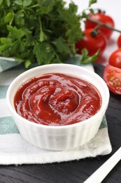 Photo of Organic ketchup in bowl on table, closeup. Tomato sauce