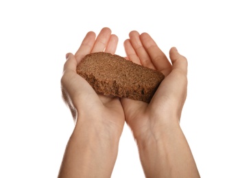 Photo of Poor woman holding piece of bread on white background, closeup