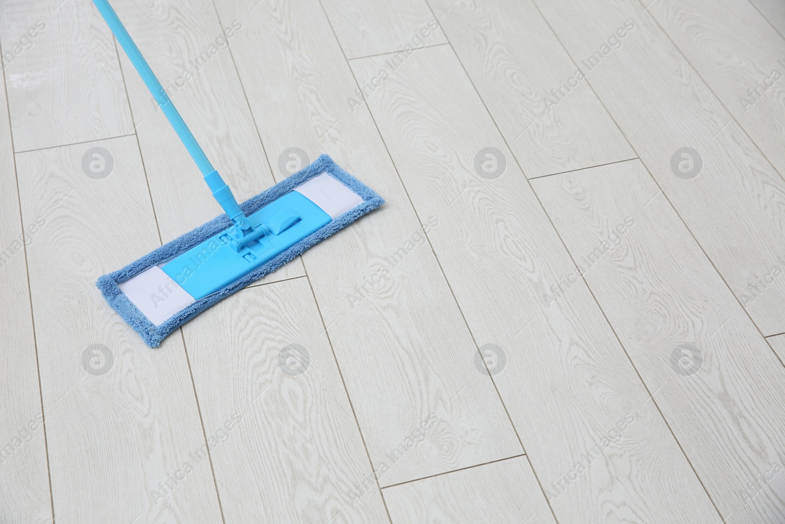 Photo of Washing of parquet floor with mop. Space for text