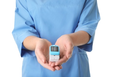Female doctor holding heart rate monitor on white background, closeup. Medical object