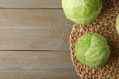 Photo of Ripe white cabbage on wooden table, flat lay. Space for text