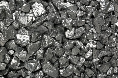 Photo of Many shiny silver nuggets as background, top view