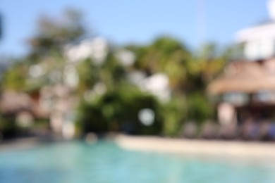 Photo of Blurred view of outdoor swimming pool at resort on sunny day