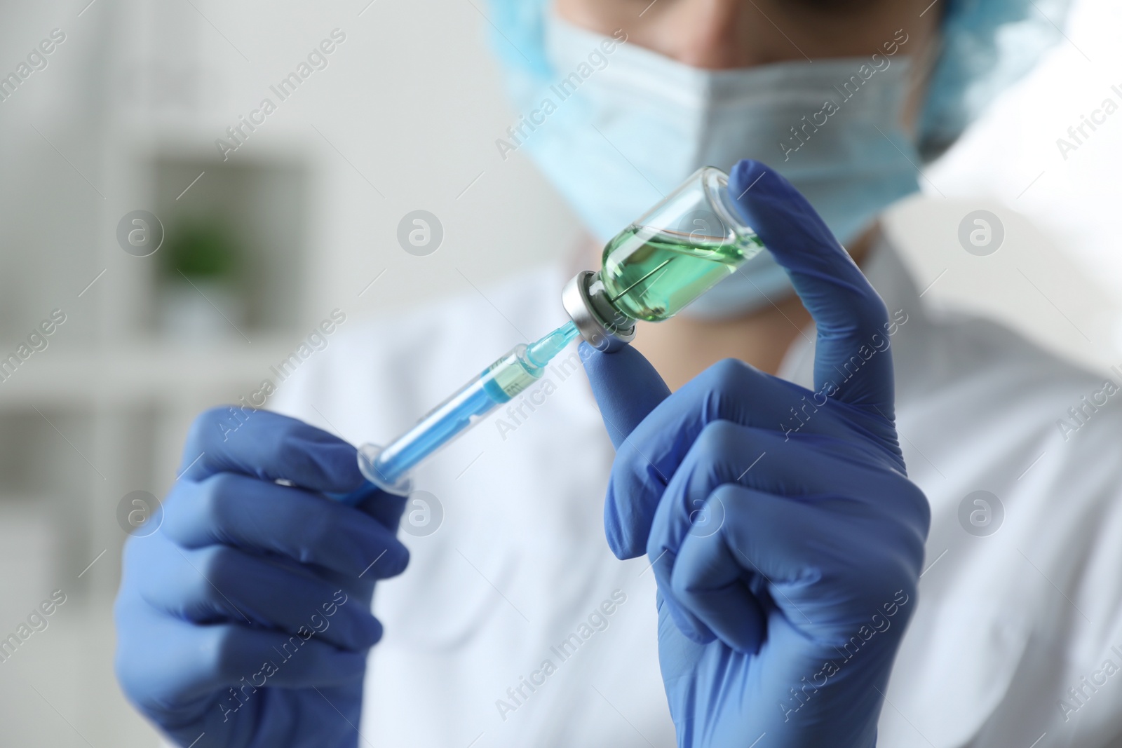 Photo of Doctor filling syringe with medication in clinic, closeup. Vaccination and immunization