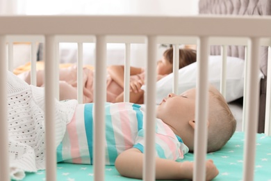 Photo of Little children sleeping in bedroom at home