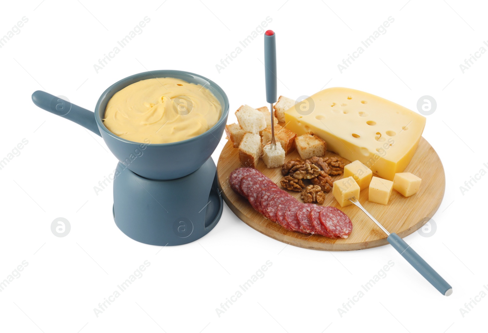 Photo of Fondue with tasty melted cheese, forks and different snacks isolated on white