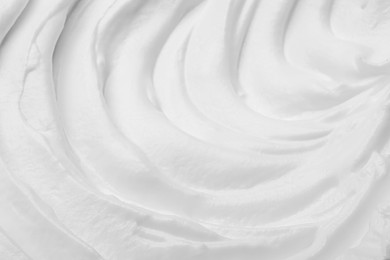 Photo of Whipped white cream as background, closeup view
