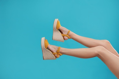 Photo of Woman in stylish shoes on light blue background