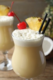 Photo of Glass of tasty Pina Colada cocktail, closeup