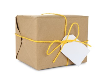 Photo of Parcel wrapped in kraft paper with tag on white background