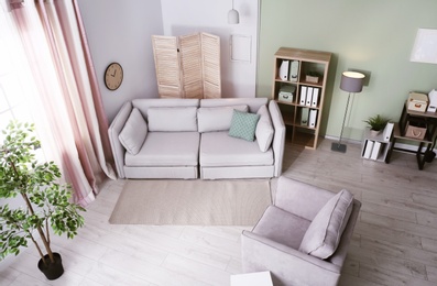 Photo of Living room interior with comfortable sofa, view through CCTV camera
