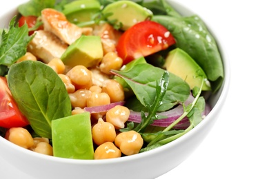 Delicious salad with chicken, avocado and chickpeas in bowl on white background, closeup