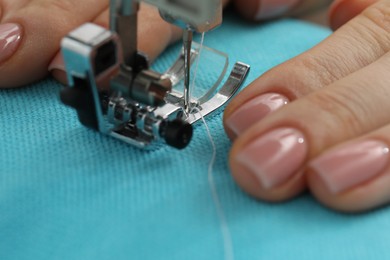 Photo of Seamstress working with sewing machine, selective focus