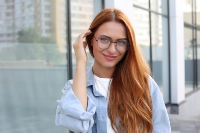Photo of Portrait of beautiful woman in glasses outdoors