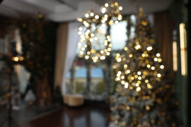 Photo of Blurred view of stylish room interior with Christmas tree and festive decor
