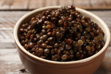 Photo of Delicious lentils in bowl on table, closeup