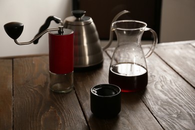 Photo of Aromatic coffee on wooden table in cafe